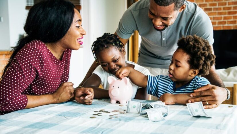 Family saving money to piggy bank